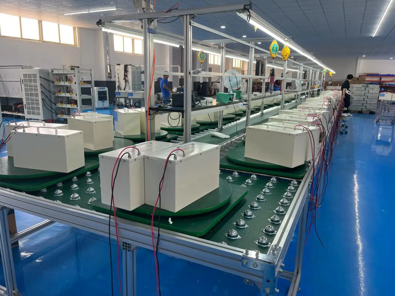 Battery units moving through a production assembly line